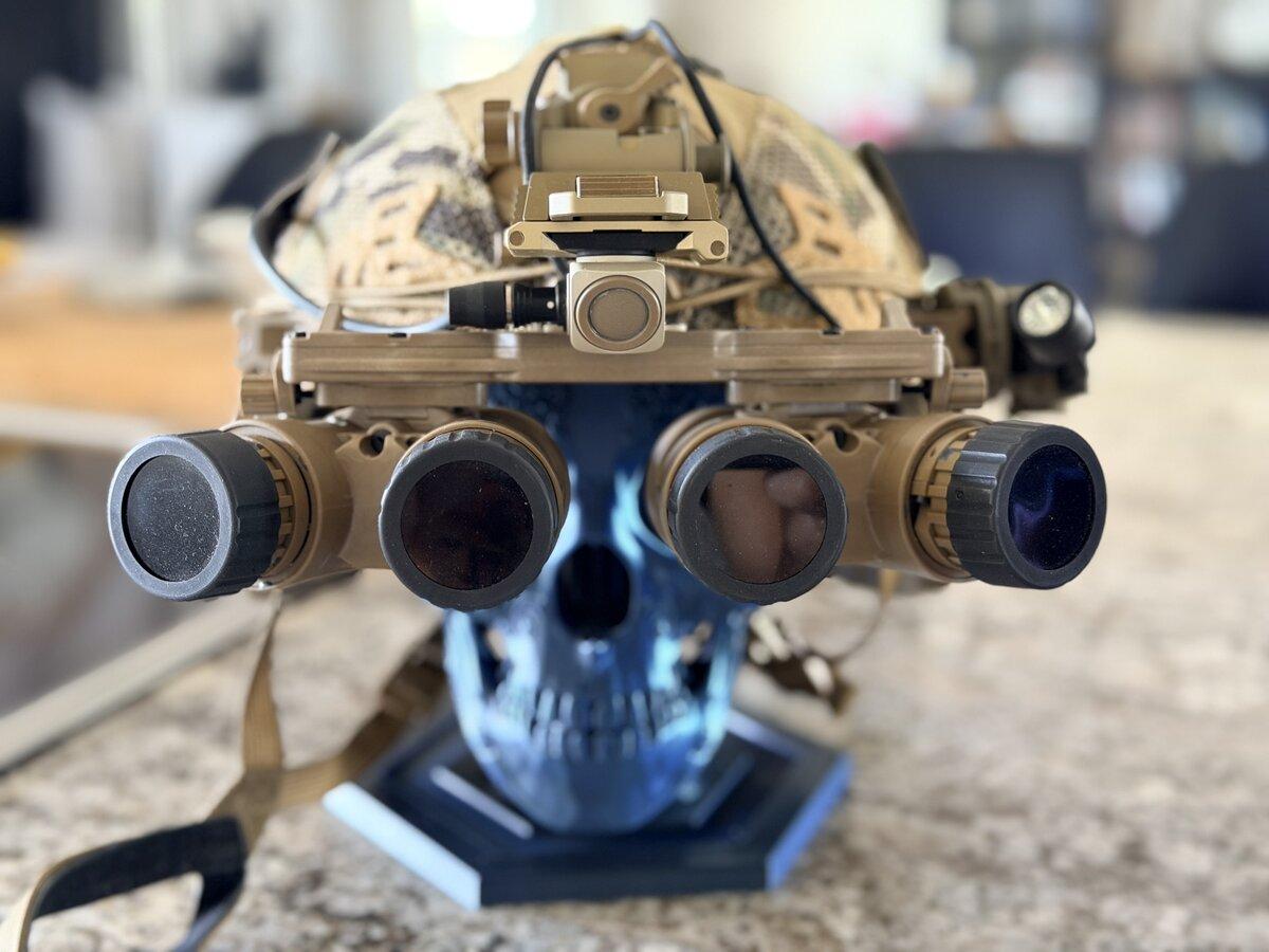 Quad-tube panoramic night vision goggles mounted on a camouflage helmet